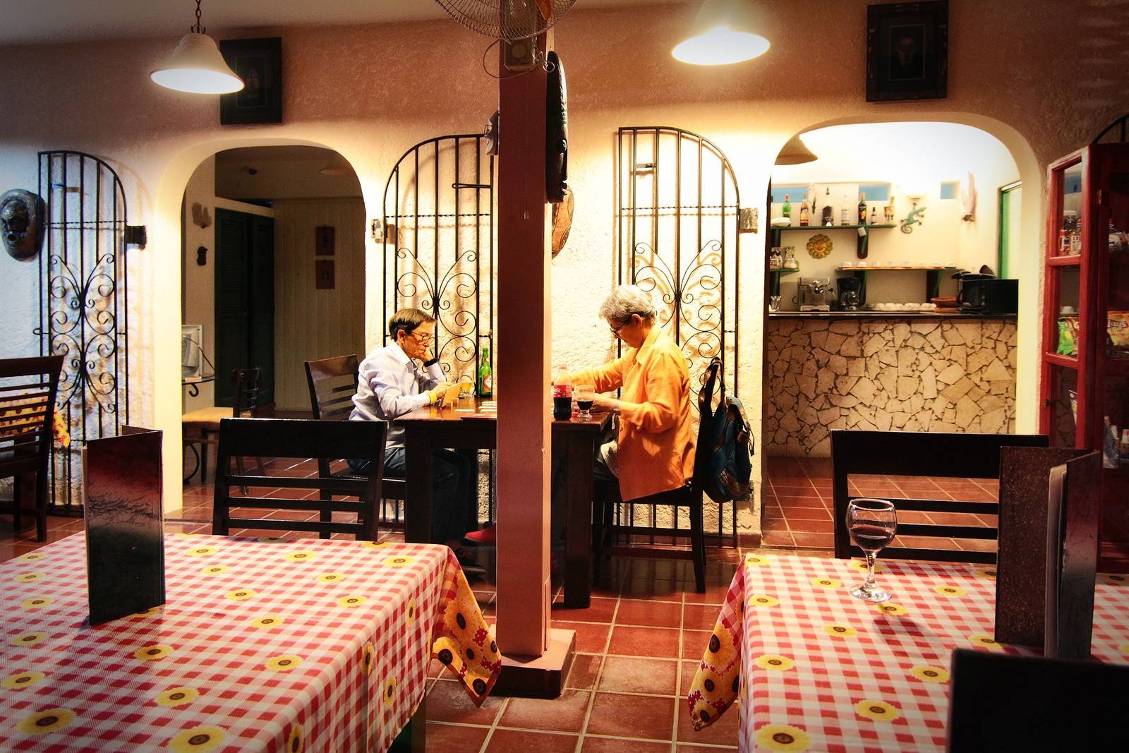Small indoor restaurant and bar with a stone wall